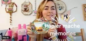 Lady craft tutor showing papier mache memory board